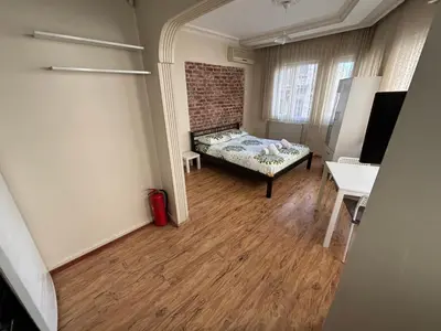 a room with a bed and a brick wall at Istanberry - Joker Apartments in Istanbul