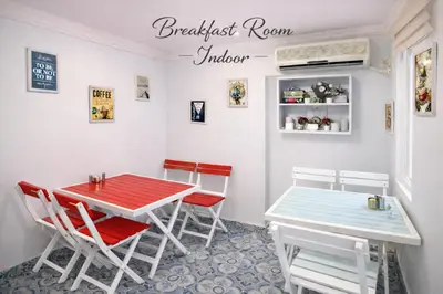 a dining room with a red and blue table and chairs at Istanberry - Joker Apartments in Istanbul