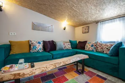 a living room with a green couch and a table at Newway Apartments in Istanbul