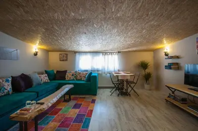 a living room with a green couch and a table at Newway Apartments in Istanbul