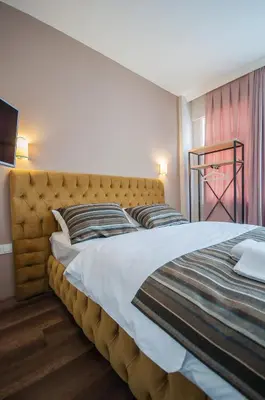 a bedroom with a large bed with a large headboard at Newway Apartments in Istanbul