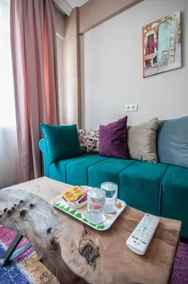 a living room with a couch and a table with a remote control at Newway Apartments in Istanbul