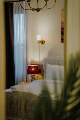 a bedroom with a bed and a table with a lamp at Leila Mansion Hotel in Tekirdag