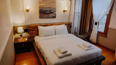 a bedroom with a bed with two towels on it at Leila Mansion Hotel in Tekirdag