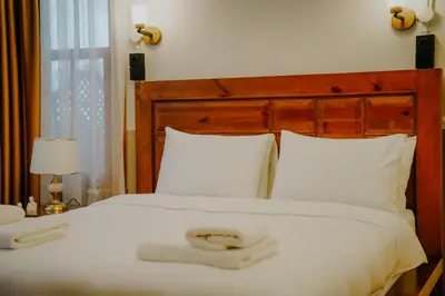 a bedroom with a large white bed with two towels on it at Leila Mansion Hotel in Tekirdag