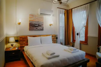 a bedroom with a bed with two towels on it at Leila Mansion Hotel in Tekirdag