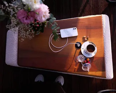 a table with a cup of coffee and flowers on it at Bell Garden Maşukiye in Kocaeli