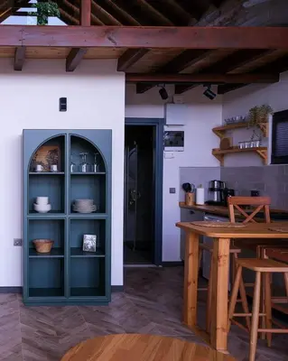 a kitchen with a green cabinet and a table at Bell Garden Maşukiye in Kocaeli
