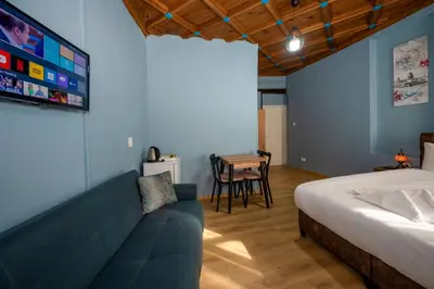 a bedroom with a bed and a couch and a table at TaksimAntiqueOtel in Istanbul