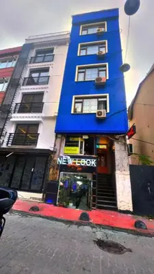 a blue and white building with a mexox store at feridiye 71 in Istanbul