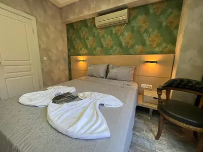 a bed with a white blanket on it in a room at feridiye 71 in Istanbul
