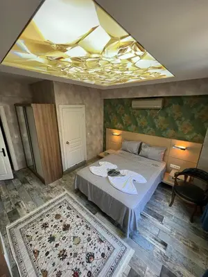 a bedroom with a large bed with a ceiling at feridiye 71 in Istanbul
