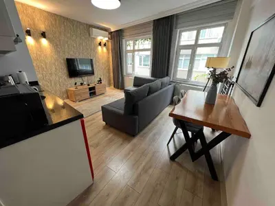 a living room with a couch and a table at Akaretler City View between Nişantaşı and Beşiktaş in Istanbul
