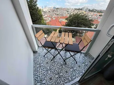 a balcony with a wooden table and chairs on a balcony at Akaretler City View between Nişantaşı and Beşiktaş in Istanbul