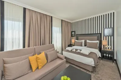 a hotel room with a bed and a couch at Avantgarde Urban Taksim in Istanbul
