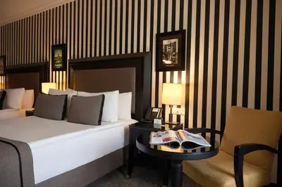 a bedroom with a bed and a table and a chair at Avantgarde Urban Taksim in Istanbul