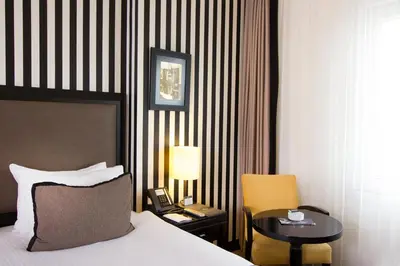 a hotel room with a bed and a table and chair at Avantgarde Urban Taksim in Istanbul
