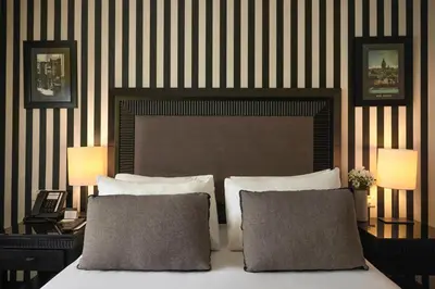 a bedroom with a bed with two lamps and two pillows at Avantgarde Urban Taksim in Istanbul