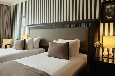 two beds in a hotel room with two lamps at Avantgarde Urban Taksim in Istanbul