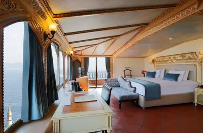 a bedroom with a bed and a couch and a table at Sultanahmet Palace Hotel in Istanbul
