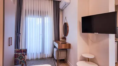 a room with a large window and a flat screen tv at Agion Living Taksim Cihangir in Istanbul