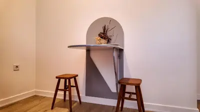 a table and two stools in a room at Agion Living Taksim Cihangir in Istanbul