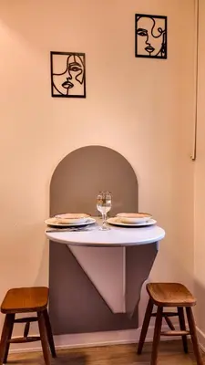 a table with two chairs and a wine glass on it at Agion Living Taksim Cihangir in Istanbul