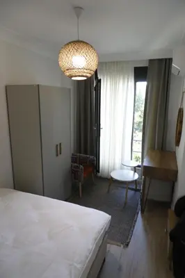 a bedroom with a bed and a living room at Agion Living Taksim Cihangir in Istanbul