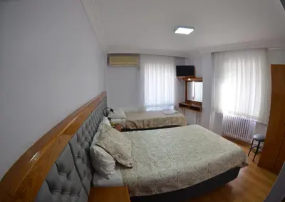 a hotel room with two beds and a staircase at Hotel Padova in Istanbul