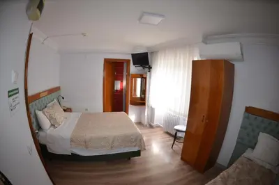 a small bedroom with a bed and a couch at Hotel Padova in Istanbul