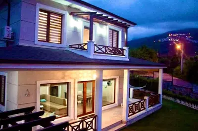 a house with a view of the backyard at night at Ada Villam in Sapanca