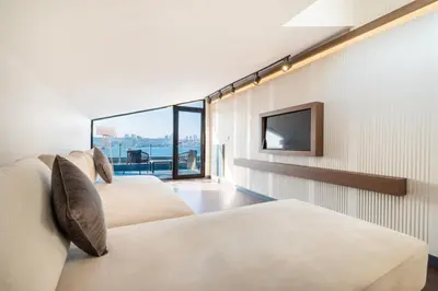 a bedroom with three beds and a tv at 216 Bosphorus Suite in Istanbul