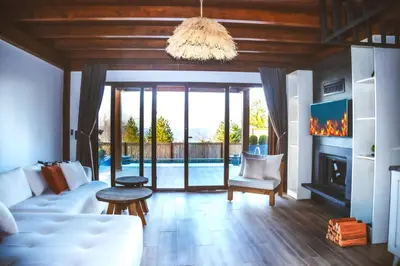 a living room with a white couch and a fireplace at Exclusive Hill Sapanca in Sapanca