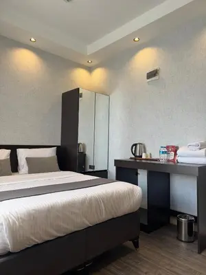 a bedroom with a large bed and a desk at Grand Armada Hotel in Avcılar