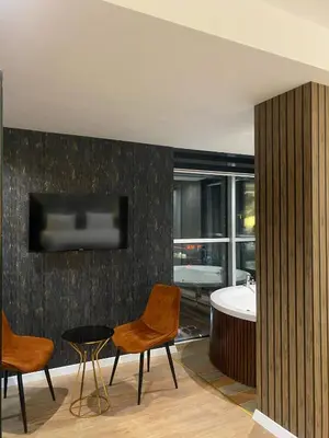 a bathroom with a tub and a table and chairs at Grand Armada Hotel in Avcılar