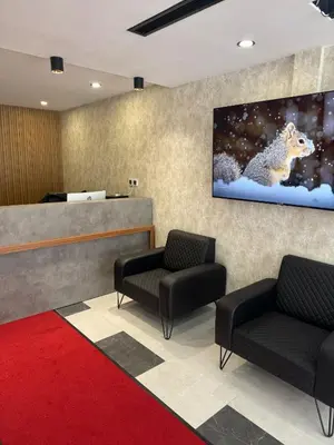 a waiting room with two chairs and a tv on the wall at Grand Armada Hotel in Avcılar
