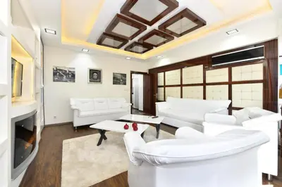 a living room with white furniture and a fireplace at Castle Suite in Istanbul