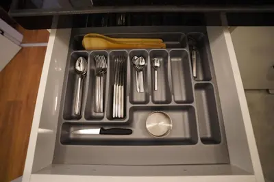 a drawer in an oven with utensils at Hotel Almina İnn in Istanbul