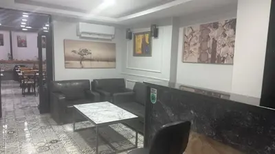a waiting room with couches and a table and chairs at Hotel Almina İnn in Istanbul