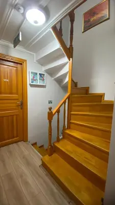 a staircase in a house with wooden floors and a door at Tree House Otel in Istanbul