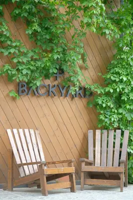 two wooden chairs sitting in front of a wall at Backyard Sapanca in Sapanca