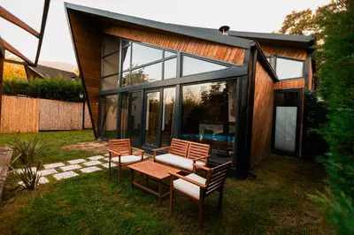 a house with glass doors and a table and chairs at Backyard Sapanca in Sapanca