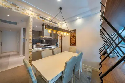a dining room and kitchen with a table and chairs at Taksim Petek Residence by Guestteori in Istanbul