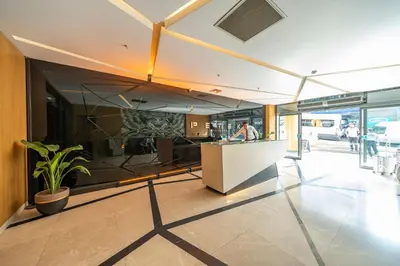a lobby of a building with a counter and a person at Taksim Petek Residence by Guestteori in Istanbul