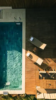 a pool with a table and chairs next to the water at Casa Vera Villa in Sakarya