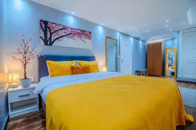 a bedroom with a large yellow bed and blue walls at Galata Nil Suite in Istanbul