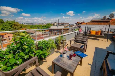 a balcony with a table and chairs on a roof at Galata Nil Suite in Istanbul