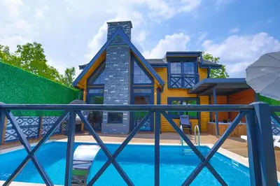 a house with a swimming pool in front of a house at MSC Bungalov Sapanca in Sapanca
