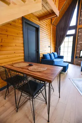 a wooden room with a table and chairs and a couch at MSC Bungalov Sapanca in Sapanca