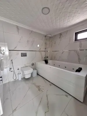 a white bathroom with a tub and a toilet at Daly Resort 2 in Sapanca